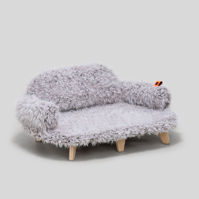 Gray fuzzy sofa with wooden legs on a light gray background