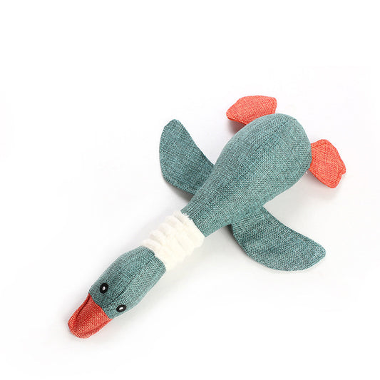 Textured green and red duck toy on a white background