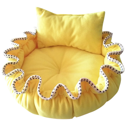 Yellow pet bed with ruffled edge and pillow on a white background