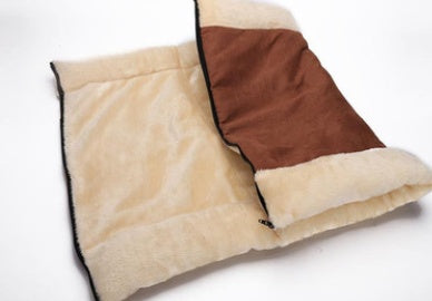 Beige and brown pet bed on a white background