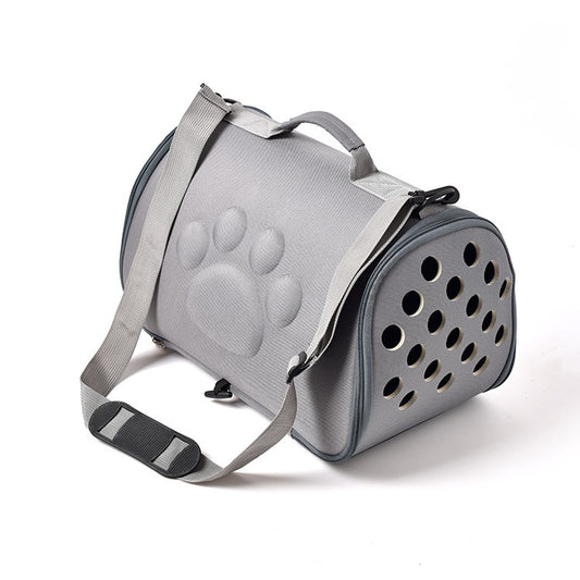 Gray pet carrier with paw print design on a white background