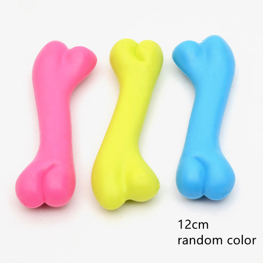 Three colorful bone-shaped toys in pink, yellow, and blue on a white background.