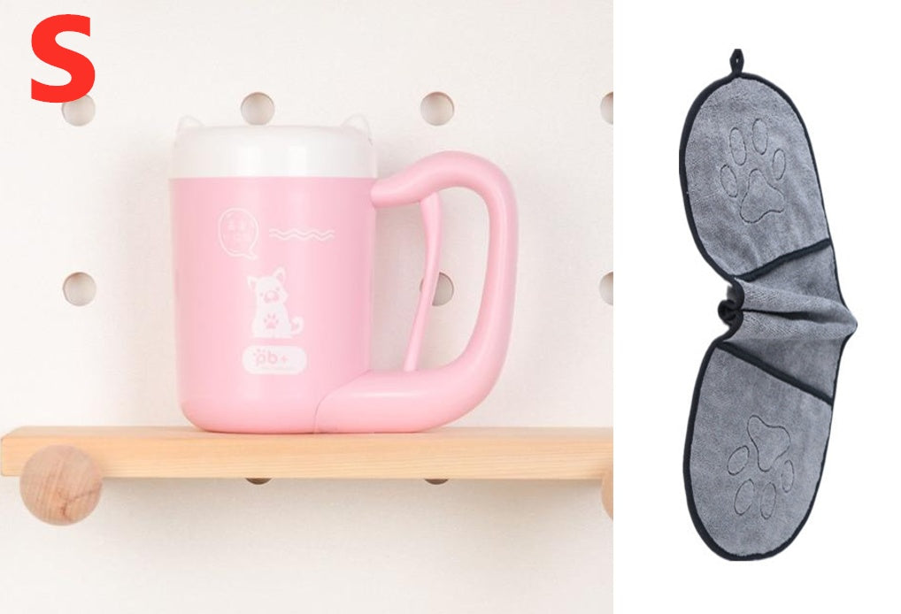 Pink mug on a wooden shelf with a gray paw-patterned towel hanging on a white wall.