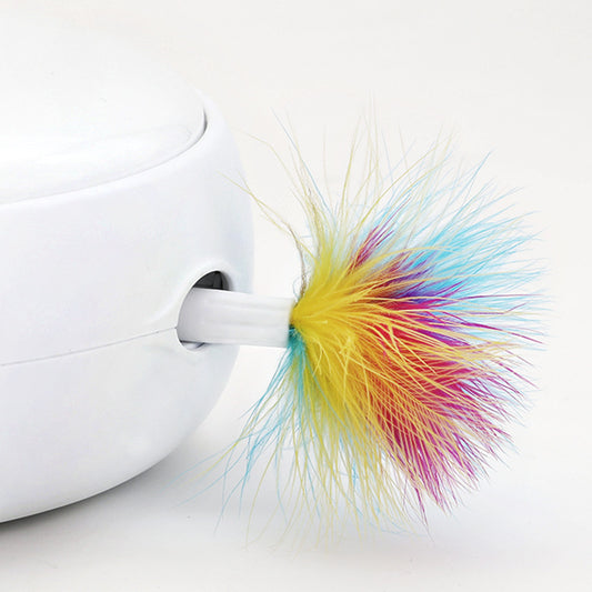 Colorful fluffy keychain attached to a white device on a light gray background