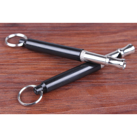 Black and silver tool with keychain on a wooden surface