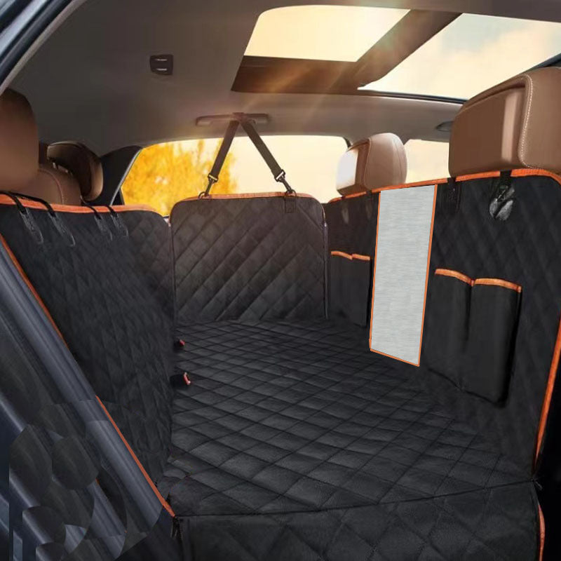 Car interior with a black quilted bench cover and orange accents.