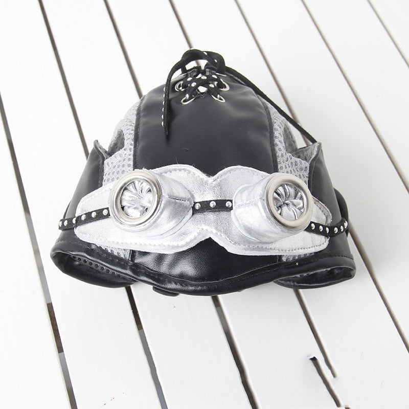 Black and white steampunk-style helmet on a wooden surface