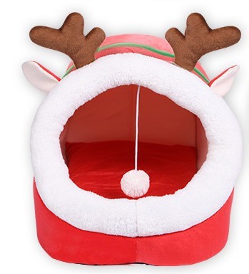 Red pet bed with reindeer antlers and ears on a white background