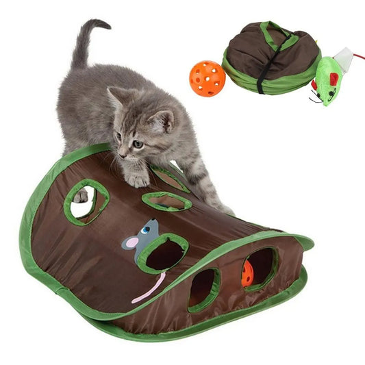 Cat playing with a brown and green cat toy shaped like a snake, with a small orange ball and green mouse toy.