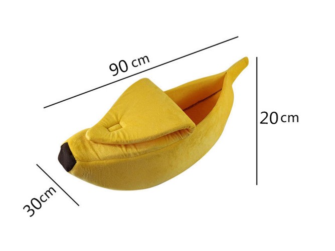 Yellow plush banana-shaped pet bed with measurements on a white background