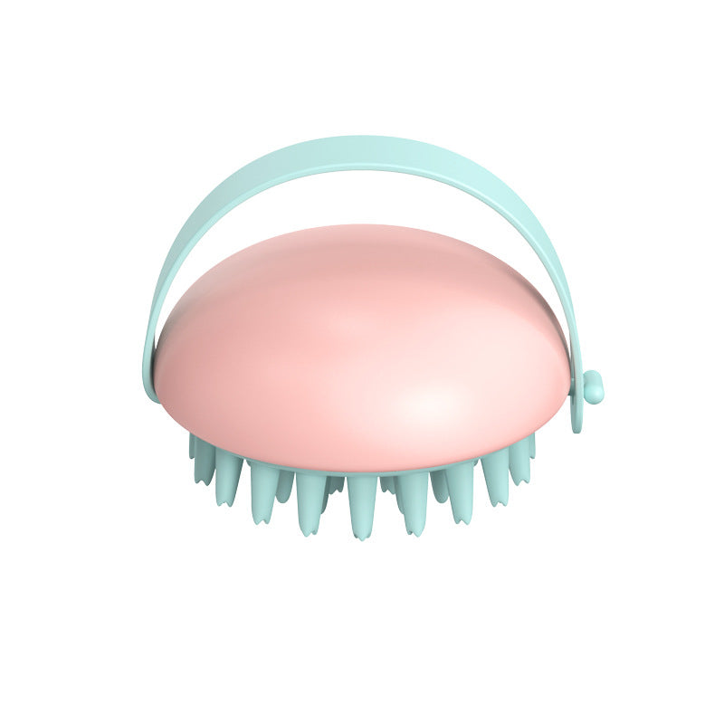 Pink scalp massager with light blue handle on a white background