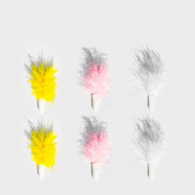Set of colorful feather dusters on a light gray background