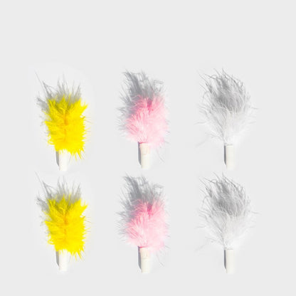 Set of colorful feather dusters on a light gray background