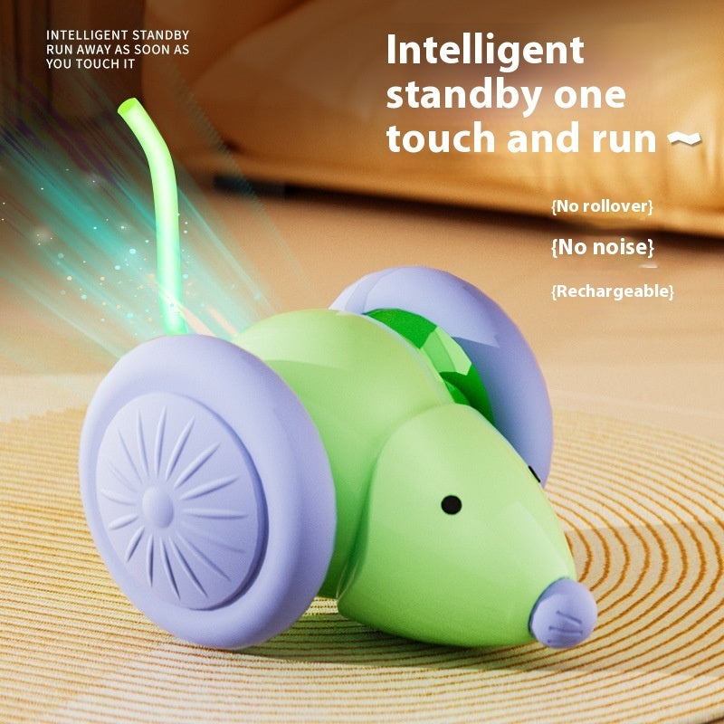 Green and purple toy mouse with glowing tail on a textured surface