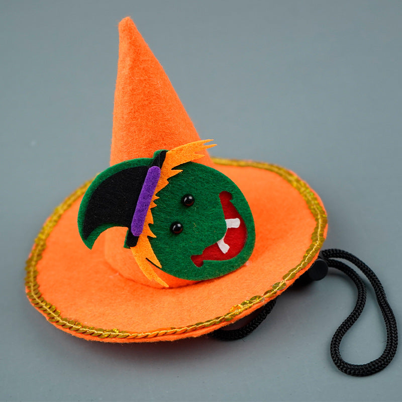Orange witch hat with a green face on a gray background