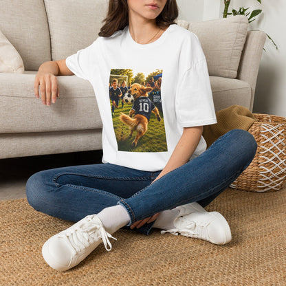 A woman sitting on a woven rug in front of a beige couch, wearing a white graphic t-shirt with a printed photo of a dog playing soccer, blue jeans, and white sneakers.