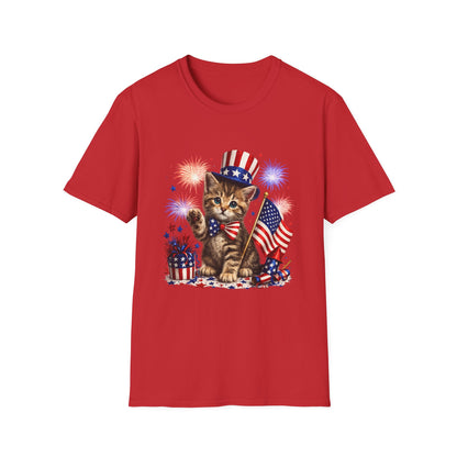 Red t-shirt with a kitten wearing an American flag hat and holding an American flag, surrounded by fireworks on a white background.