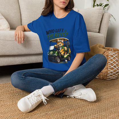 A royal blue short-sleeve crewneck t-shirt featuring a cartoon graphic of a cat driving a green golf cart with the text 'WHO LEFT THE KEYS?' printed on the chest.