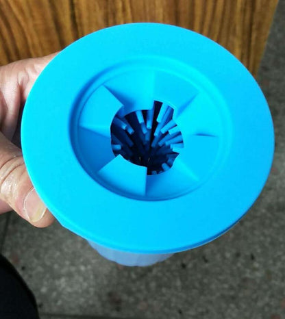 Blue plastic component held by a hand with a blurred background