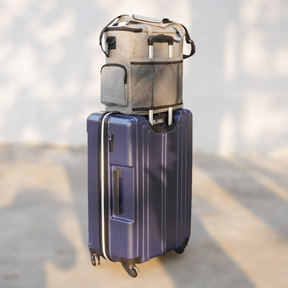 Blue suitcase with a gray bag on top against a blurred background
