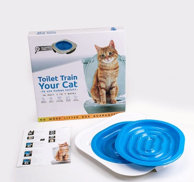 Cat training kit with 'Toilet Train Your Cat' book and blue training bowls on a white background