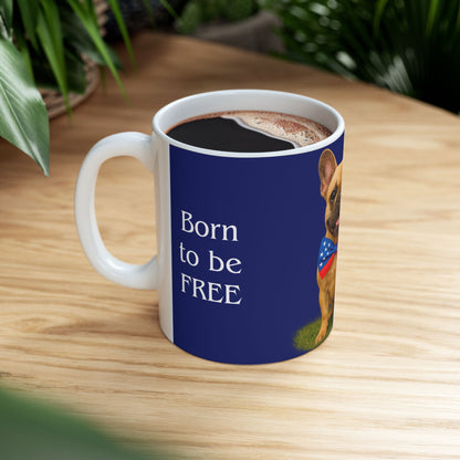 Mug with a dog illustration and text 'Born to be FREE' on a wooden table.