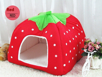 Strawberry-shaped pet bed with red and green colors on a white background