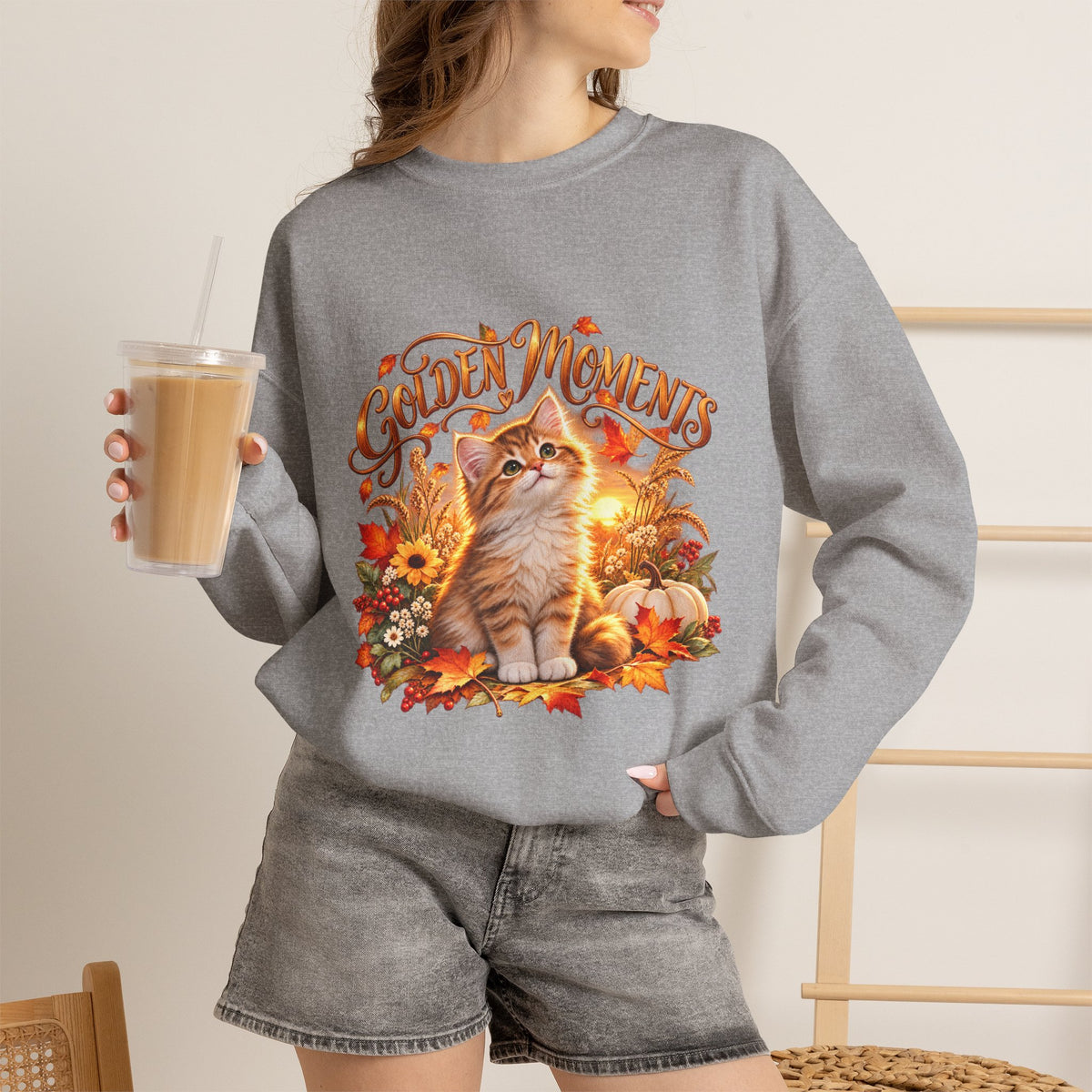 Close-up of Golden Moments orange-and-white kitten artwork printed on a fall crewneck sweatshirt
