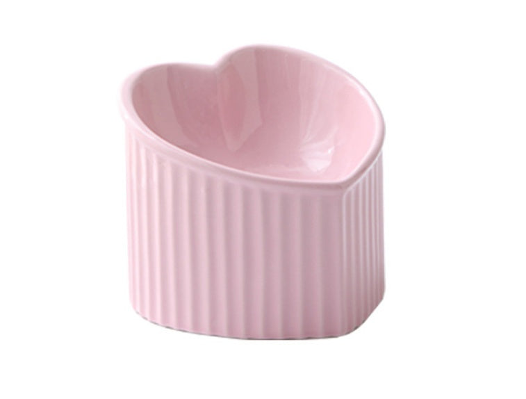 Pink heart-shaped ceramic ramekin on a white background