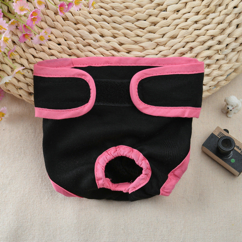 Black and pink pet diaper on a textured surface with a woven basket in the background