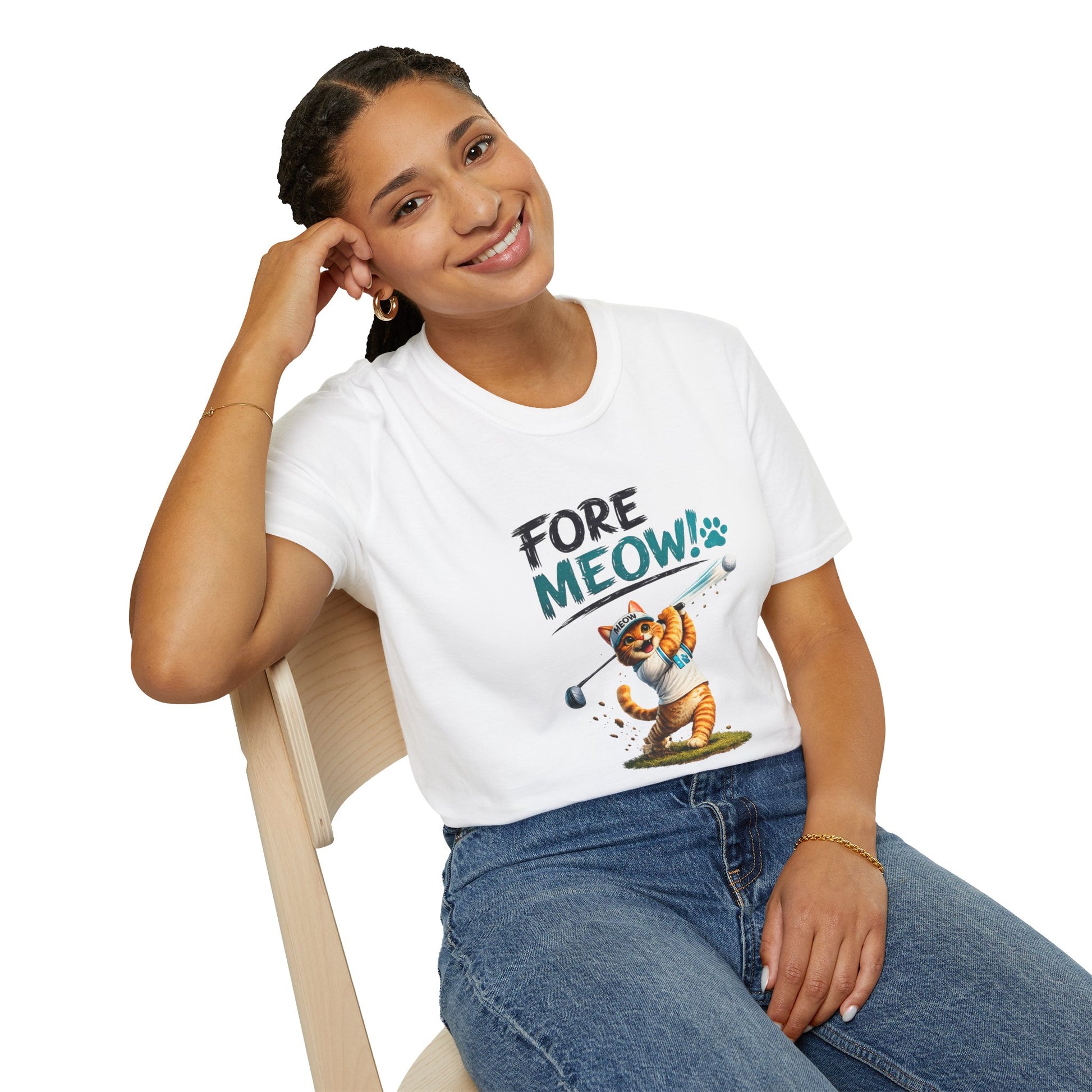 A woman sitting on a wooden chair wearing a white graphic t-shirt with the text 'FORE MEOW!' and a cartoon cat playing golf, paired with blue jeans, against a plain white background.