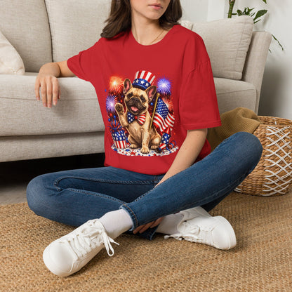 Person wearing a red t-shirt with a dog graphic and American flag design, sitting on a couch.