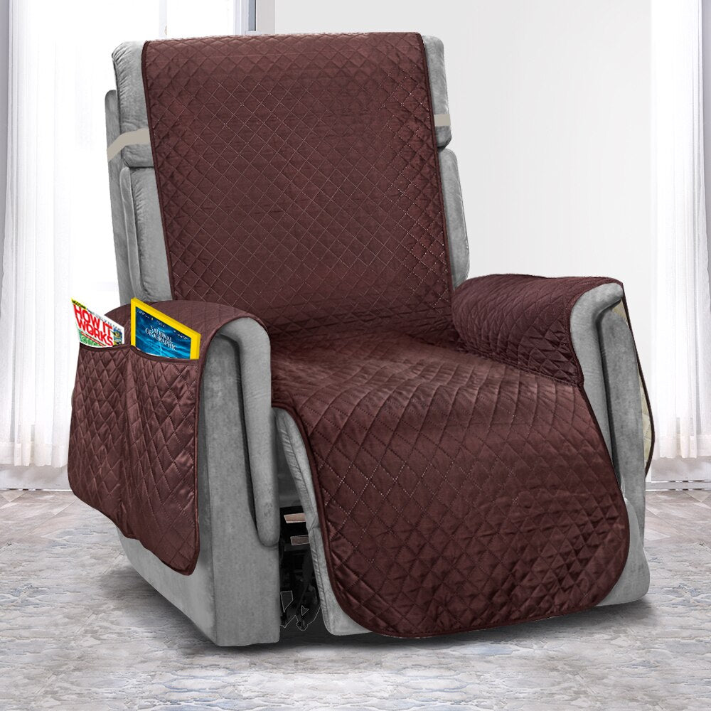 Brown and gray quilted recliner cover on a chair with visible brand labels.