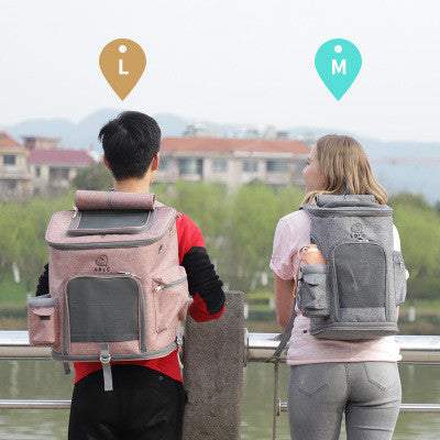 Two people wearing pet carriers with size indicators on a scenic background