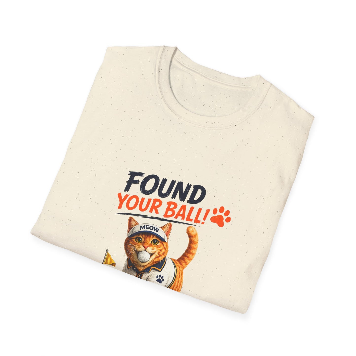 A folded natural t-shirt with a graphic print of an orange tabby cat wearing a baseball cap and holding a banana. The text above the cat reads 'FOUND YOUR BALL!' in black and orange lettering, accompanied by an orange paw print.