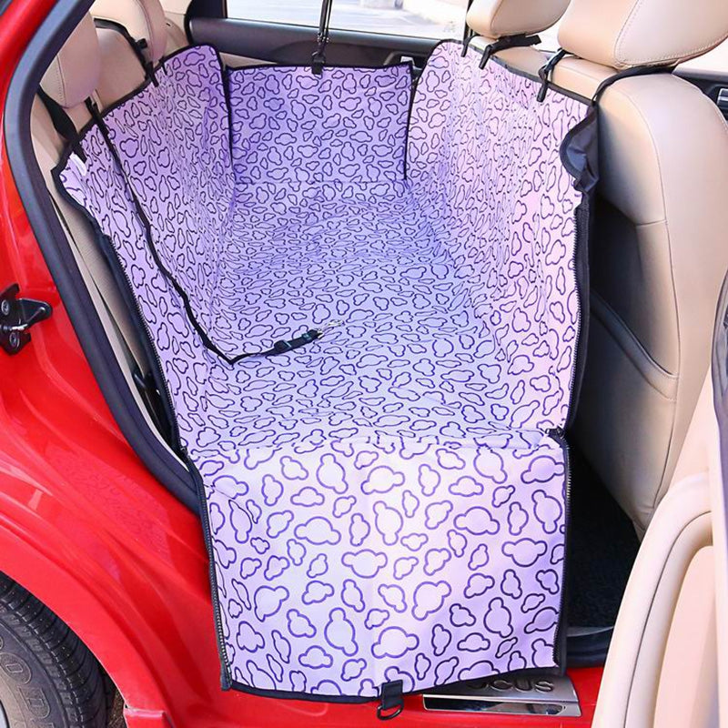 Car seat cover with purple and white pattern installed in a car.