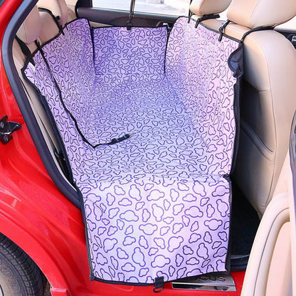 Car seat cover with purple and white pattern installed in a car.
