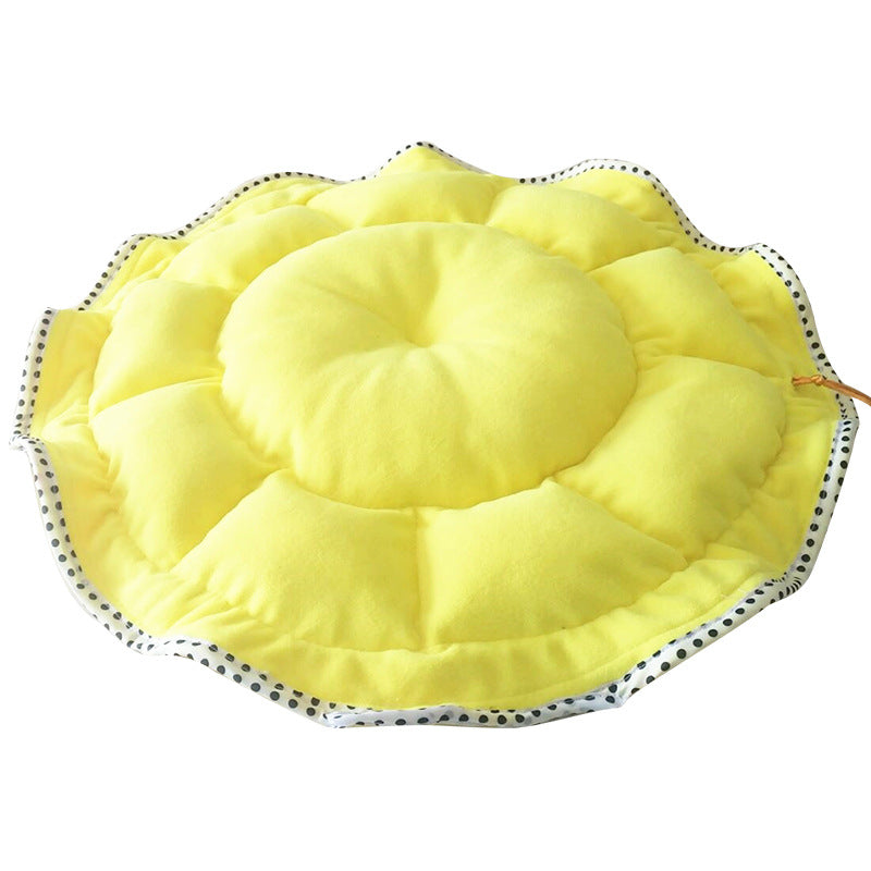 Yellow sun hat with black polka dot trim on a white background