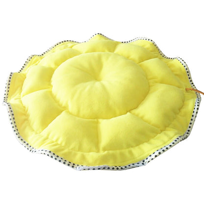 Yellow sun hat with black polka dot trim on a white background
