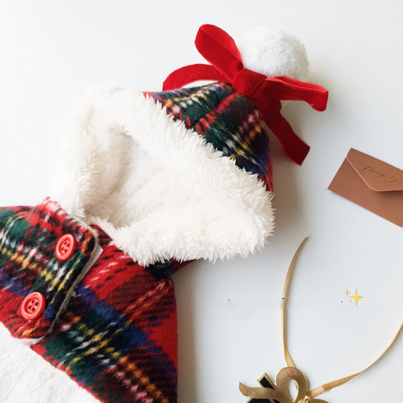 Plaid dog coat with a red bow on a white background