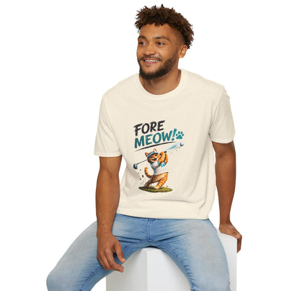 A man wearing a cream-colored graphic t-shirt with a cartoon cat illustration and the text 'FORE MEOW!'. He is sitting on a white block against a plain white background.