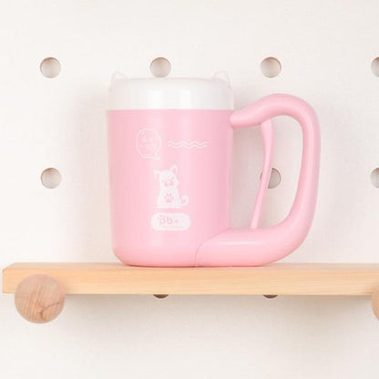 Pink mug with handle on a wooden shelf against a white background