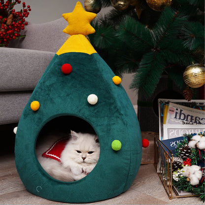 Cat inside a Christmas tree-shaped pet bed with decorations and a cat sitting inside.