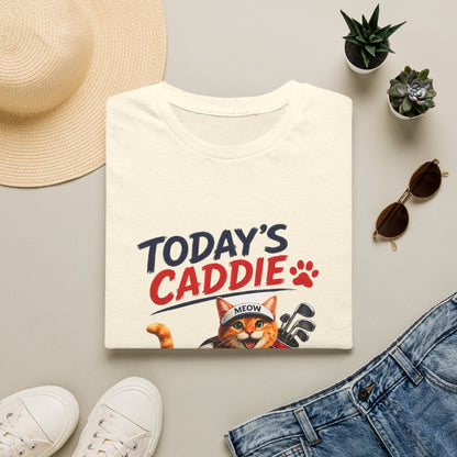 An natural short-sleeve crewneck t-shirt featuring a cartoon graphic of an orange tabby cat wearing a cap and holding golf clubs, with the text 'TODAY'S CADDIE' 
