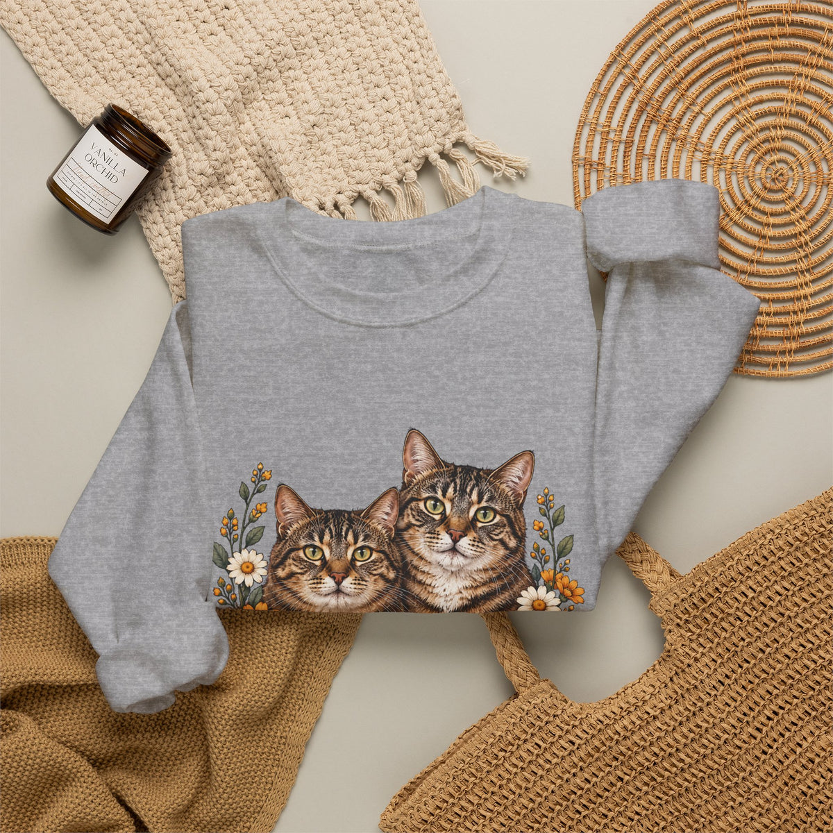Two tabby cats and wildflowers printed on a black unisex crewneck sweatshirt