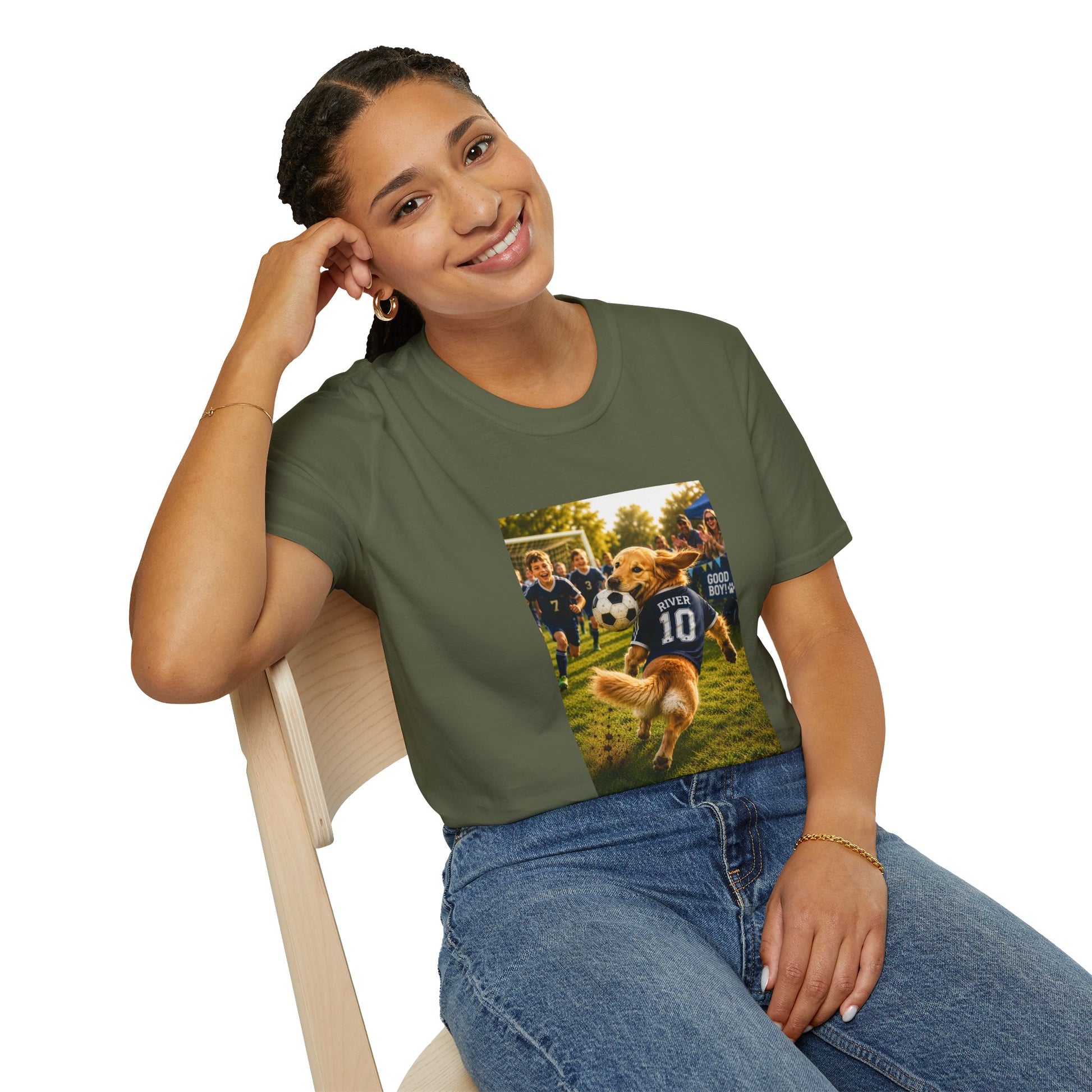 A woman wearing an olive green graphic t-shirt with a custom pet soccer print, sitting on a light wood chair against a white background.