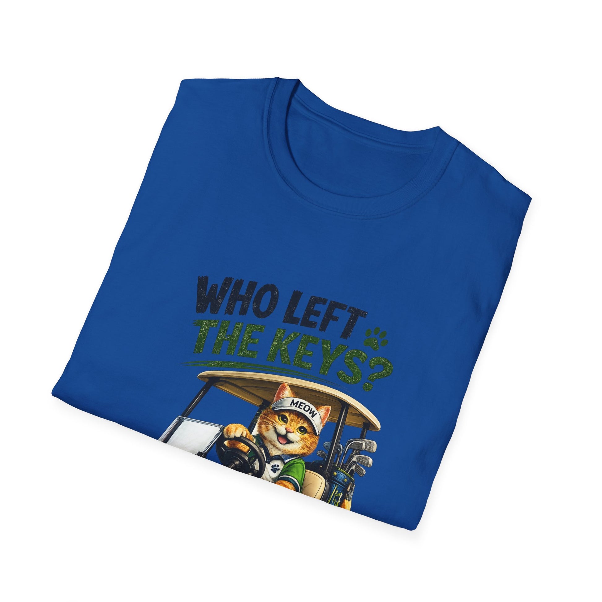 A folded royal blue t-shirt on a white background, featuring a graphic of a cartoon cat driving a golf cart with the text 'WHO LEFT THE KEYS?' in dark blue and green.