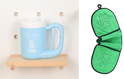 Blue mug on a wooden shelf with a green butterfly-shaped pot holder featuring paw prints.