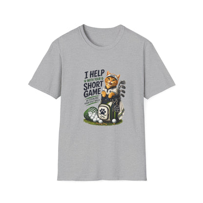 A sport grey graphic T-shirt is displayed in a styled flat lay on a light beige surface. The shirt features a cartoon cat wearing a baseball cap and holding golf clubs, with the text 'I HELP WITH YOUR SHORT GAME BY STEALING GOLF BALLS.