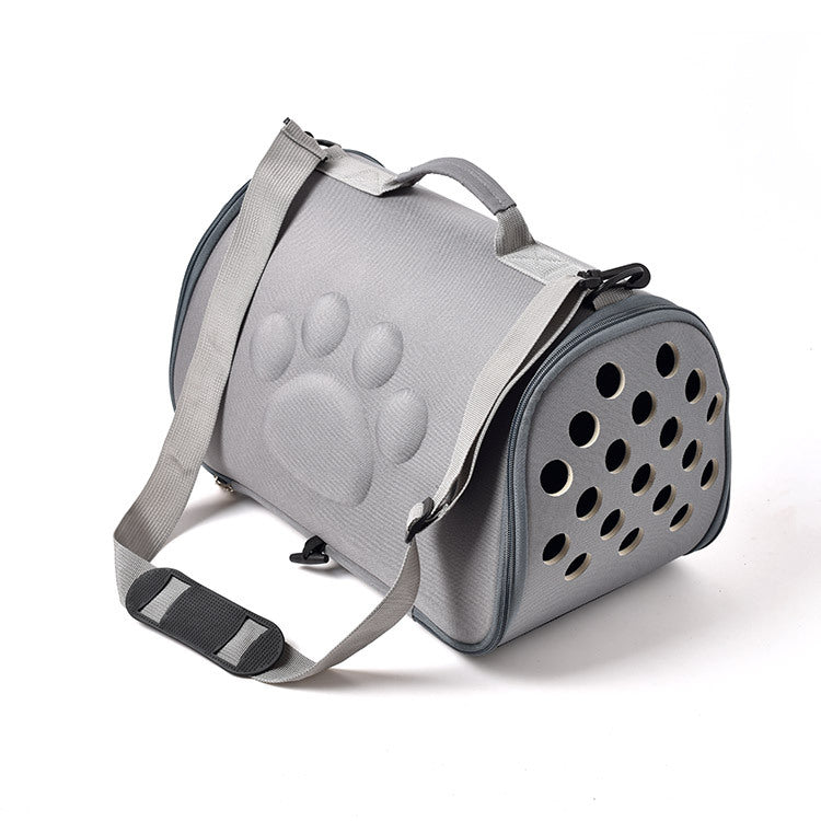 Gray pet carrier with paw print design on a white background